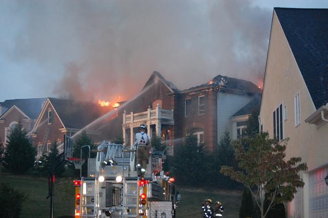 House Fire at the Tattersall development in West Bradford Township.  Assist to Station 39.  Ladder 53 setting up for master stream operations.  September 2007.