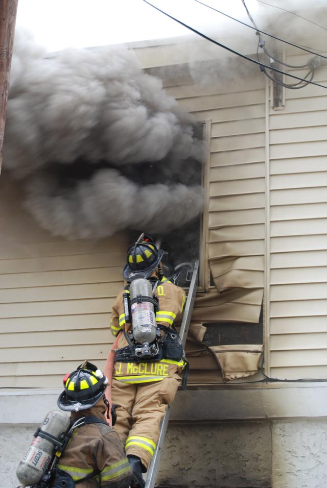 House Fire on N. Darlington Street in West Chester Borough.  Pictured FF's Justin McClure and Bob Clauhs.April 2008.