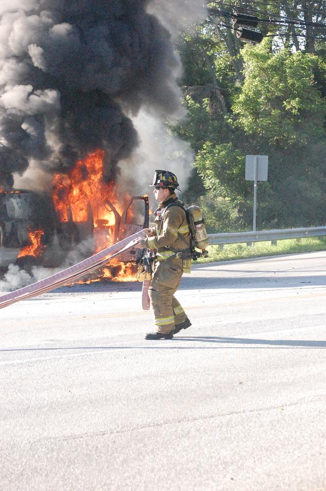 Van Fire on Rt. 52 in East Bradford Township.  FF Justin McClure stretching the front bumper line.  July 2009.