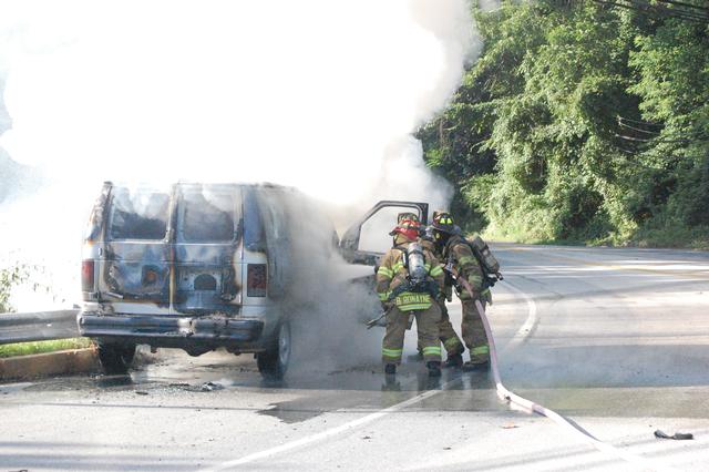 Van Fire on Rt. 52 in East Bradford Township.  FF's Justin McClure and John Morris extinguishing the fire assisted by Lt. Ronayne.  July 2009.
