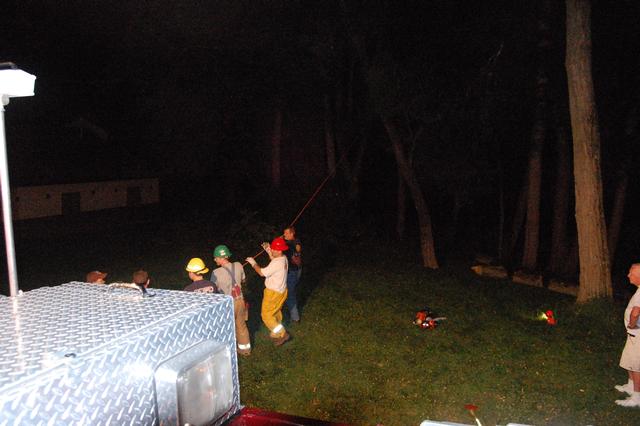 Members clearing a fallen tree at the Fire House.